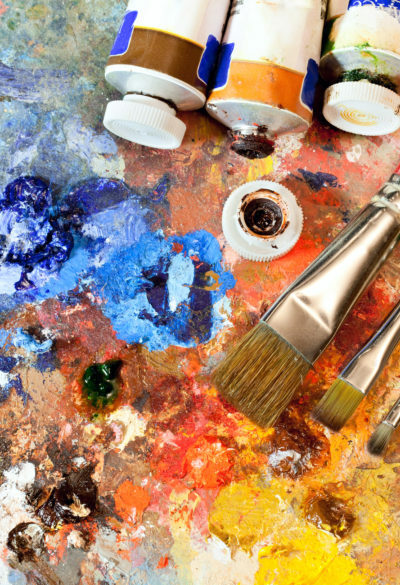 Artistic equipment: paint, brushes, spatula and art palette